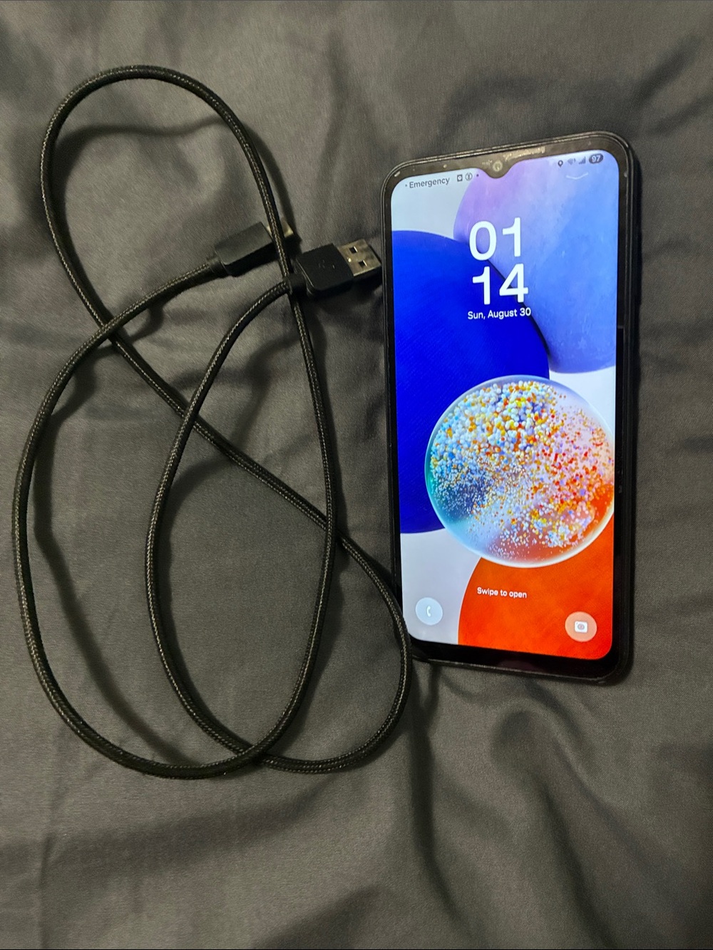Samsung Galaxy A14 5G phone with charger cord
